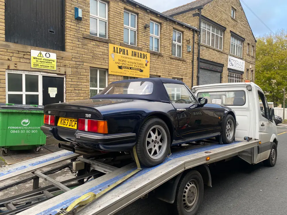 A classic British convertible loaded on an ICM flatbed on a UK street