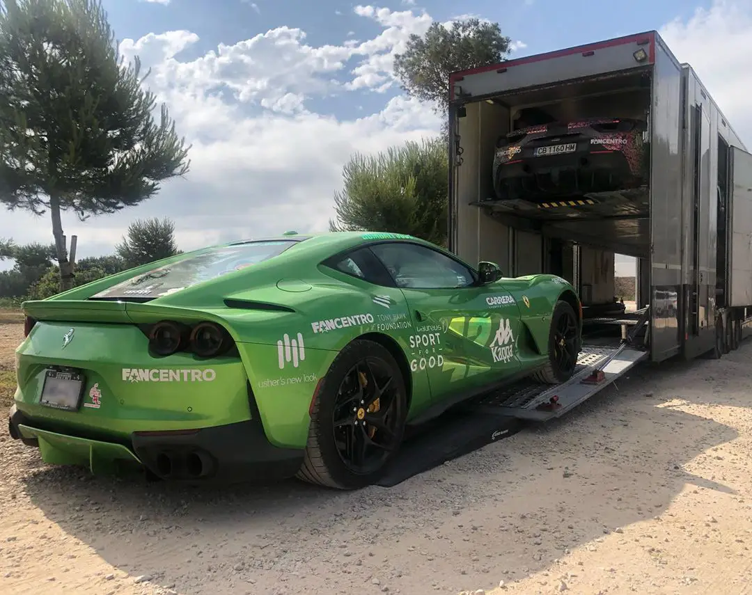 A green Ferrari being loaded into an ICM enclosed transporter