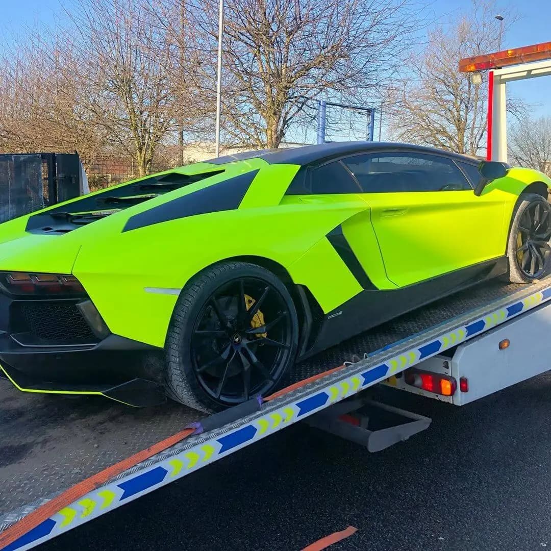 A green Lamborghini loaded on a liveried ICM transporter