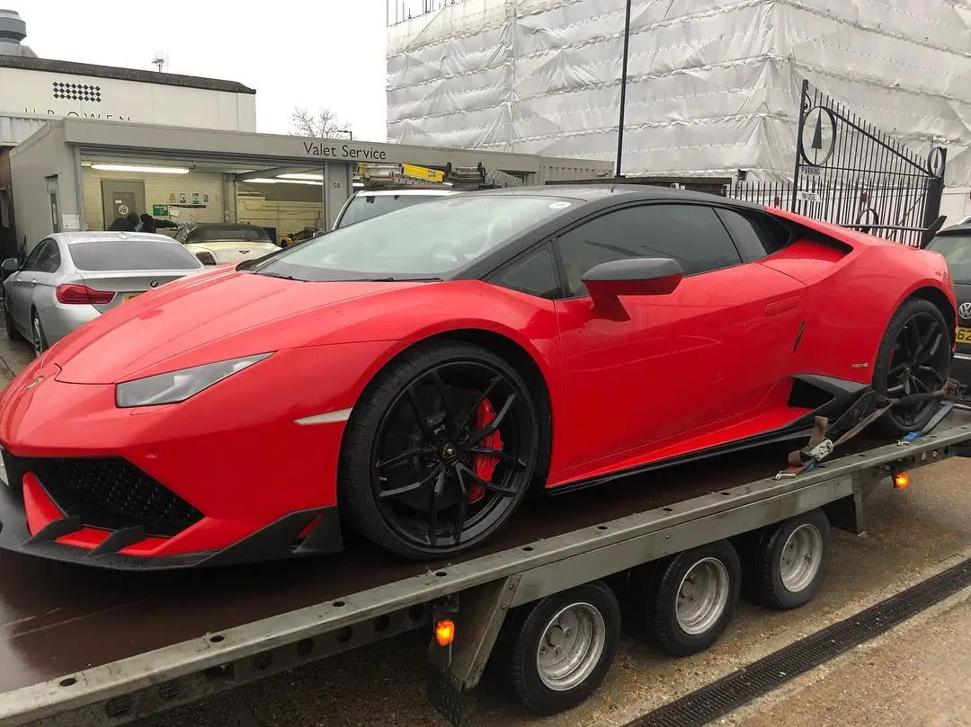 A red Lamborghini Huracán strapped down on an ICM trailer